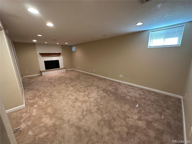 basement with a fireplace, carpet flooring, baseboards, and recessed lighting