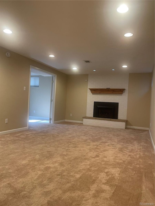 unfurnished living room featuring carpet floors, baseboards, visible vents, and recessed lighting