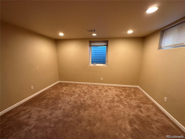 finished below grade area featuring visible vents, baseboards, carpet floors, and recessed lighting