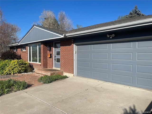 ranch-style house with brick siding, driveway, and a garage
