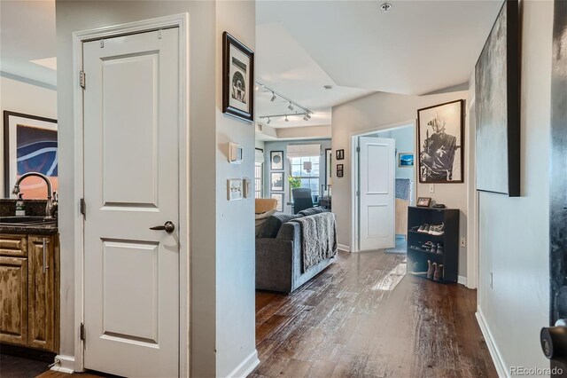 hallway featuring dark hardwood / wood-style flooring and sink