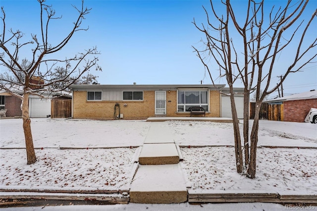 single story home with an attached garage and brick siding