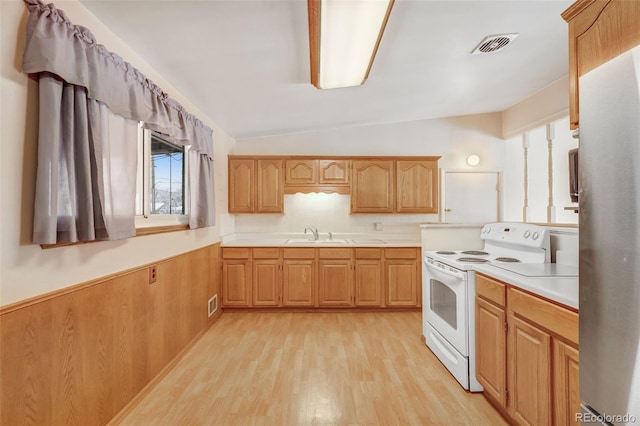 kitchen with a wainscoted wall, lofted ceiling, light countertops, white electric range, and visible vents