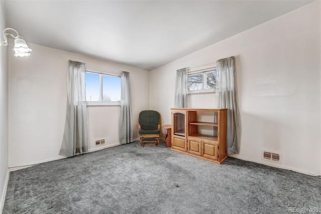 unfurnished room featuring plenty of natural light, carpet flooring, and visible vents