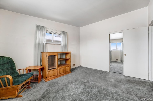 interior space featuring dark colored carpet and visible vents