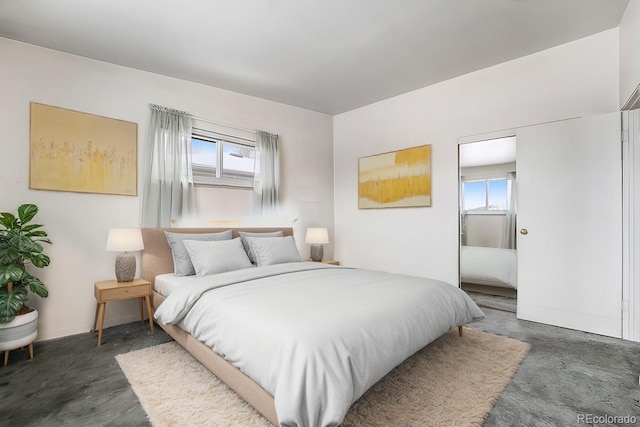 bedroom with multiple windows and baseboards