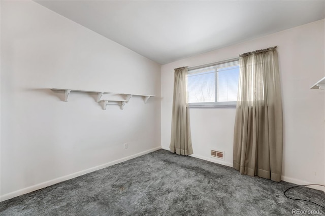 unfurnished room featuring carpet floors, baseboards, visible vents, and vaulted ceiling