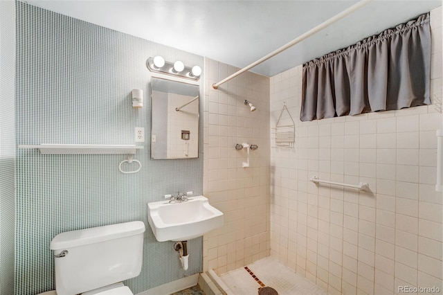 bathroom with a shower stall, toilet, and tile walls