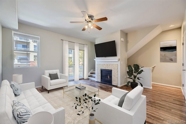 living room featuring ceiling fan and hardwood / wood-style flooring