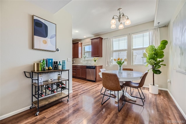 dining area with a chandelier, dark hardwood / wood-style flooring, and sink