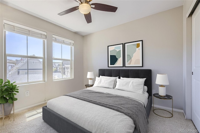 bedroom featuring ceiling fan, a closet, and light carpet