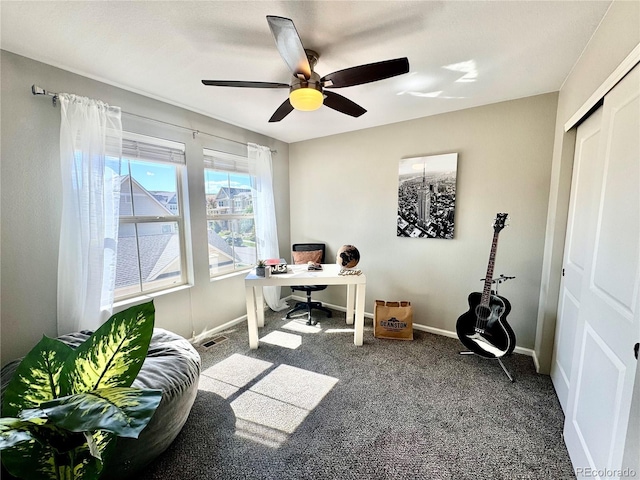 carpeted office space with ceiling fan