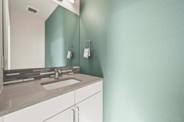 2004 Foxtail Ln Unit B, Lafayette, CO 80026 - bathroom with vanity, tasteful backsplash, and a textured wall