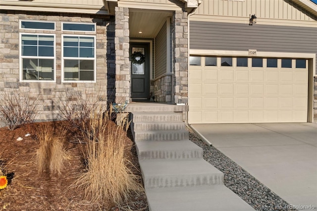 property entrance featuring stone siding, board and batten siding, and concrete driveway