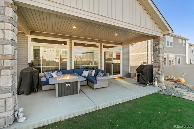 view of patio / terrace featuring an outdoor living space with a fire pit, fence, and grilling area