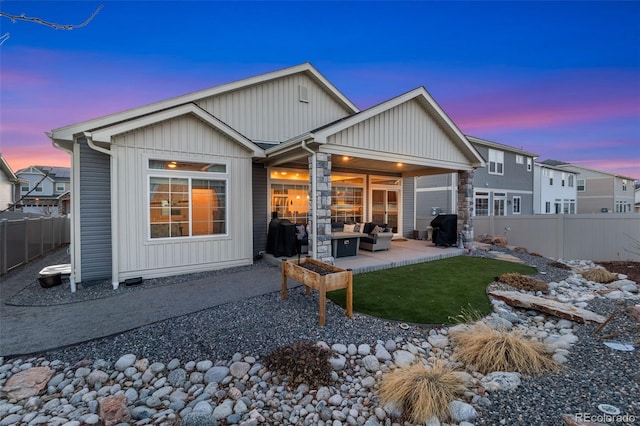 back of property with a patio, outdoor lounge area, and fence