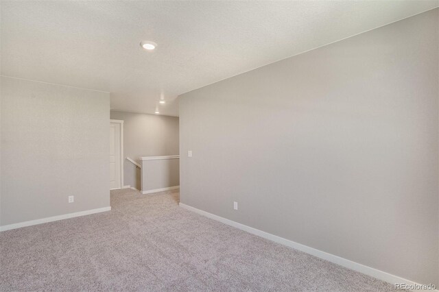 13477 Valentia St, Thornton, CO 80602 - spare room with light carpet, recessed lighting, and baseboards