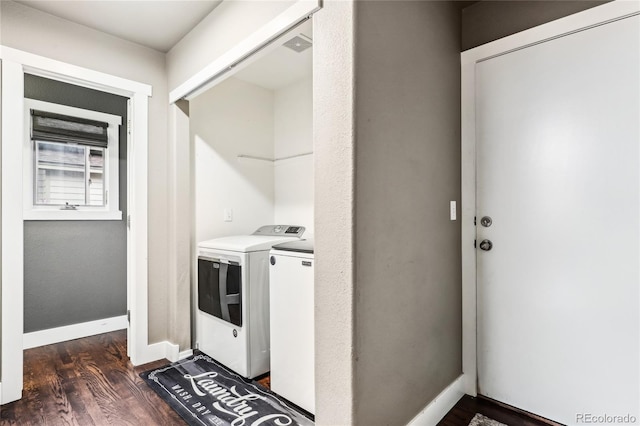 laundry room with laundry area, washer and clothes dryer, baseboards, and dark wood-style floors
