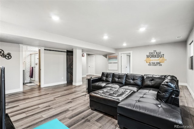 living room with baseboards, recessed lighting, and light wood finished floors