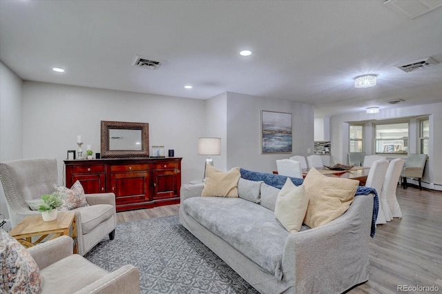 7427 S Ames Ct, Littleton, CO 80128 - living area featuring light wood-type flooring, recessed lighting, and a baseboard heating unit