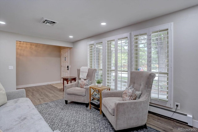 7427 S Ames Ct, Littleton, CO 80128 - living area featuring a baseboard radiator, wood finished floors, and recessed lighting