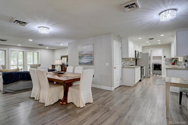 7427 S Ames Ct, Littleton, CO 80128 - dining area featuring light wood-style flooring and recessed lighting