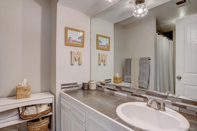 7427 S Ames Ct, Littleton, CO 80128 - bathroom with vanity and decorative backsplash