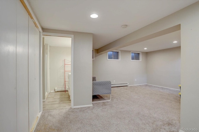7427 S Ames Ct, Littleton, CO 80128 - finished basement with a baseboard heating unit, carpet flooring, and recessed lighting