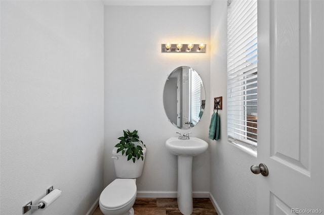 bathroom featuring hardwood / wood-style floors and toilet