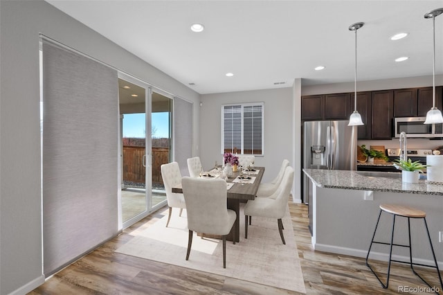 dining space featuring light hardwood / wood-style flooring