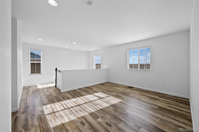 empty room with dark hardwood / wood-style floors