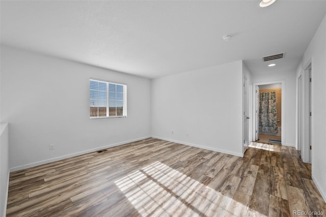 unfurnished room with hardwood / wood-style floors