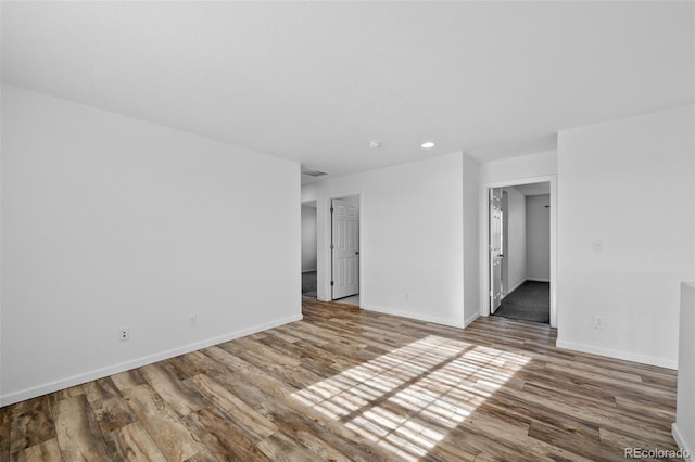 spare room with hardwood / wood-style floors