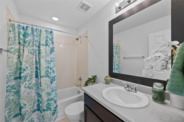 full bathroom featuring vanity, shower / tub combo, and toilet