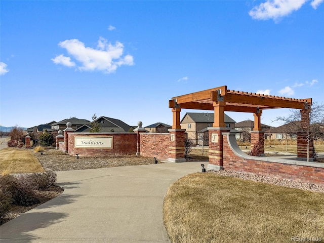 view of community featuring a pergola and a yard