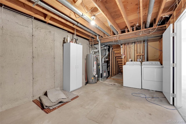 basement with washing machine and dryer and water heater