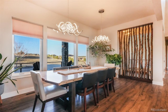 dining area featuring visible vents, baseboards, an inviting chandelier, and wood finished floors