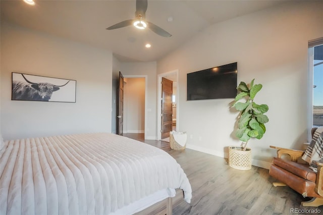 bedroom featuring ceiling fan, baseboards, lofted ceiling, recessed lighting, and wood finished floors