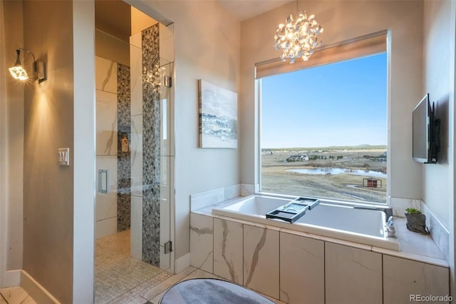 full bath with an inviting chandelier, a bath, and a shower stall