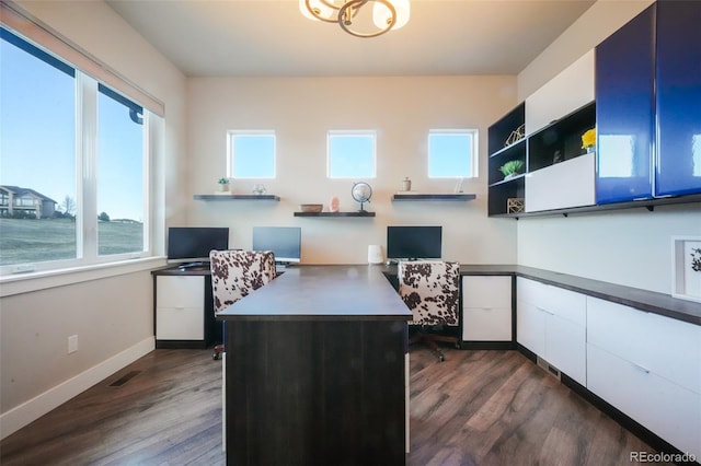 office featuring visible vents, dark wood-type flooring, and baseboards