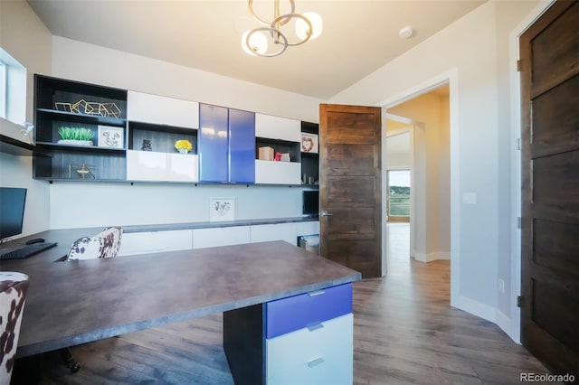 kitchen with baseboards, open shelves, dark wood-style flooring, dark countertops, and a notable chandelier