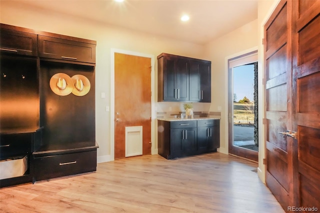 kitchen with recessed lighting, light wood-type flooring, baseboards, and light countertops