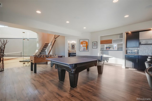 recreation room with recessed lighting, wood finished floors, and built in features