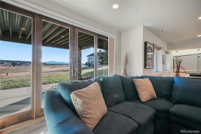 living room featuring recessed lighting, wood finished floors, and a mountain view