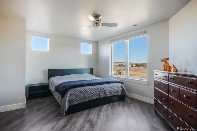 bedroom with visible vents, ceiling fan, dark wood-type flooring, and baseboards