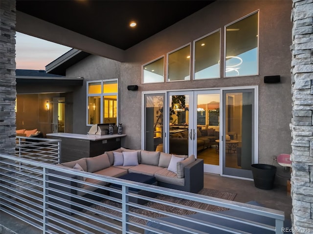 patio terrace at dusk featuring french doors and an outdoor hangout area