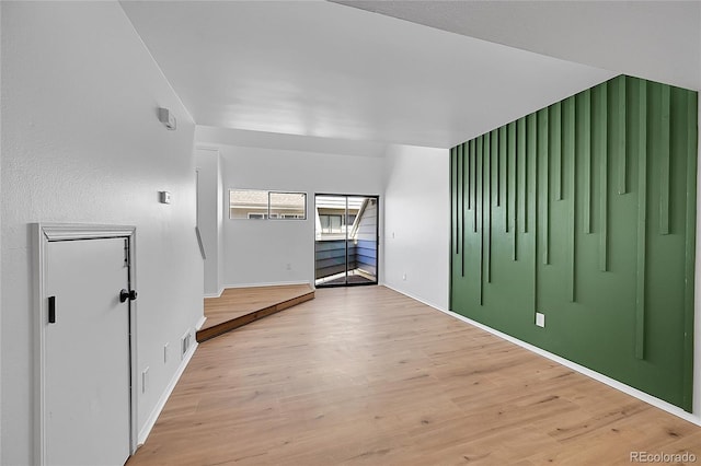 empty room with light wood finished floors and baseboards