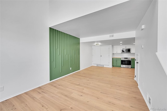 unfurnished living room featuring visible vents and light wood-style floors