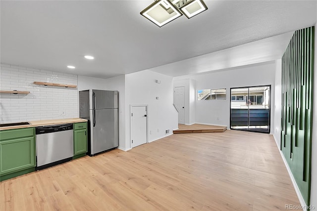 kitchen with light wood finished floors, open shelves, green cabinetry, stainless steel appliances, and butcher block counters