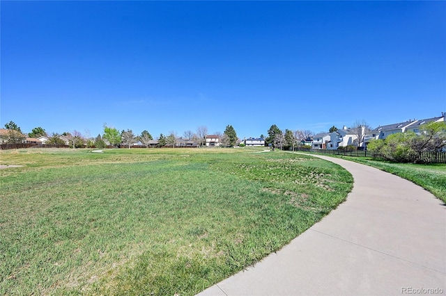 surrounding community featuring a lawn and a residential view